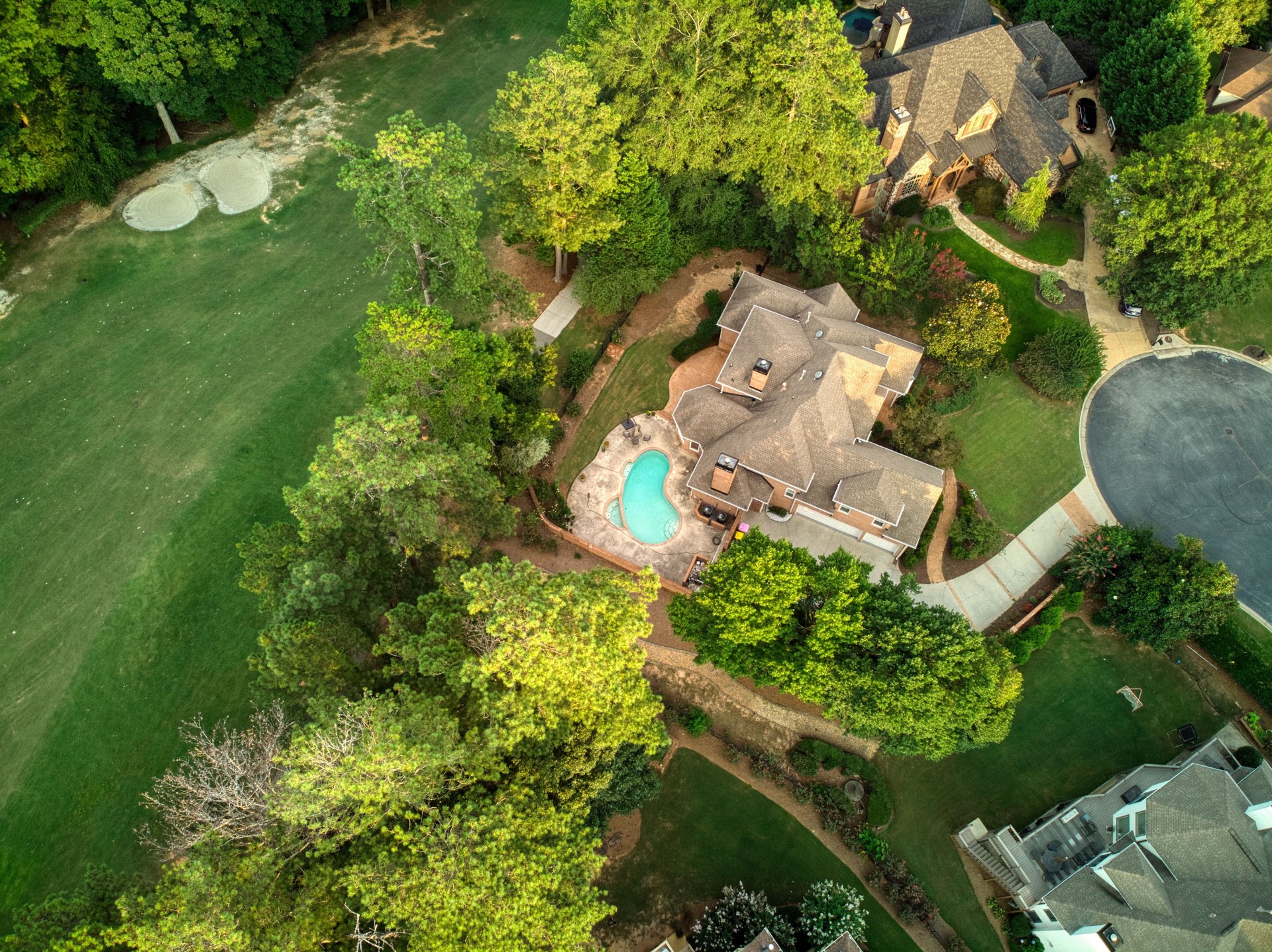Aerial panoramic view of an upscale subdivision shot during golden hour.
