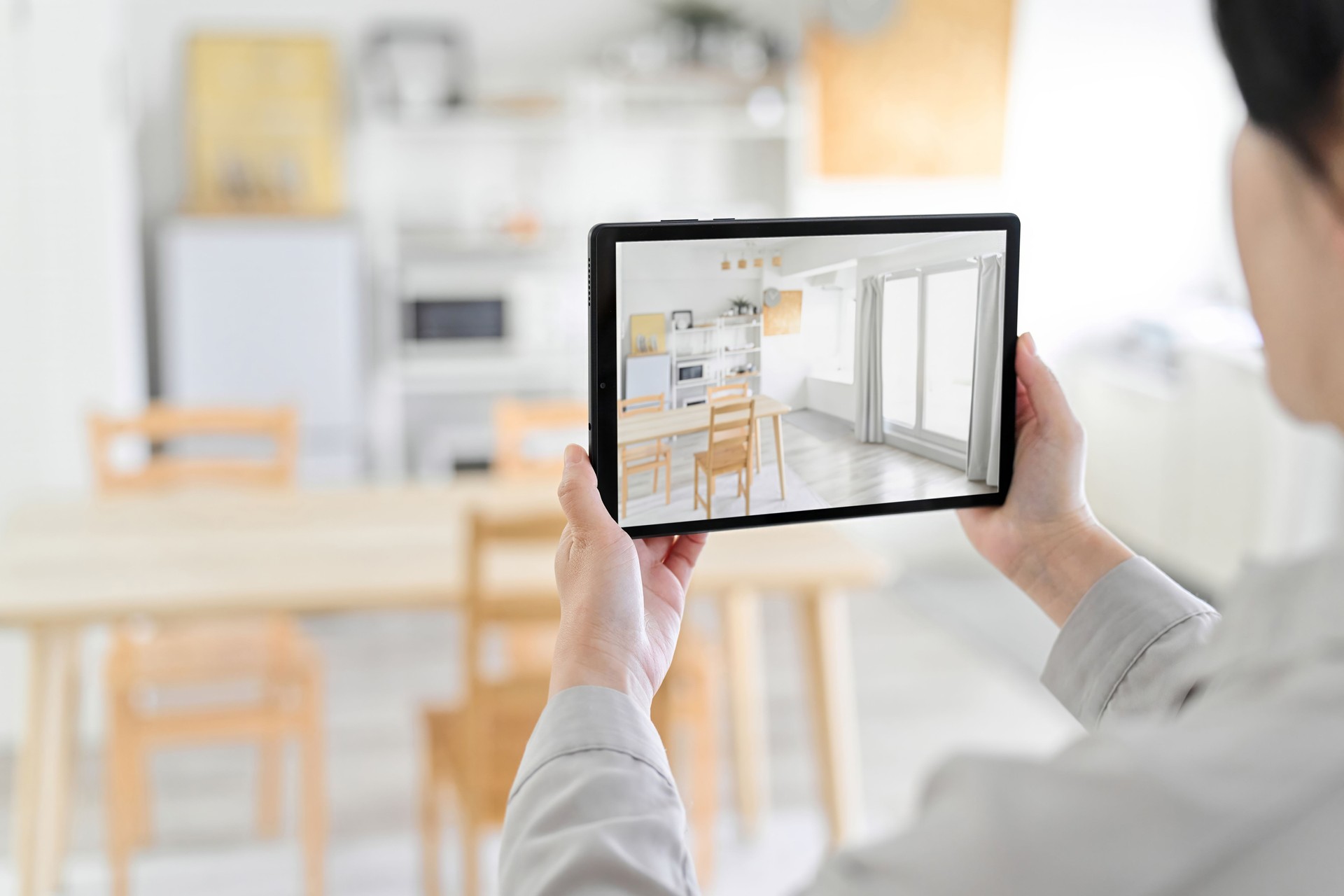 A woman using an AR app to simulate furniture placement